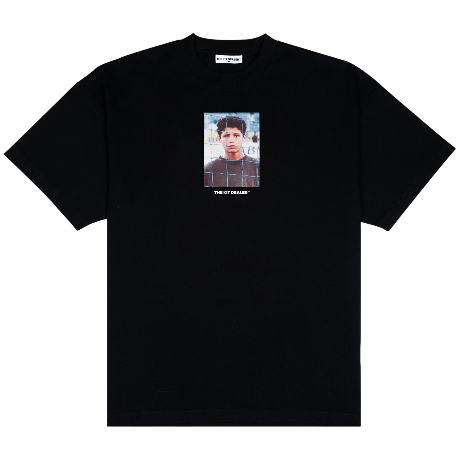 Funchal Tee, front: black heavyweight cotton tee printed with a photo of a young Cristiano Ronaldo behind a goal net, THE KIT DEALER wordmark below